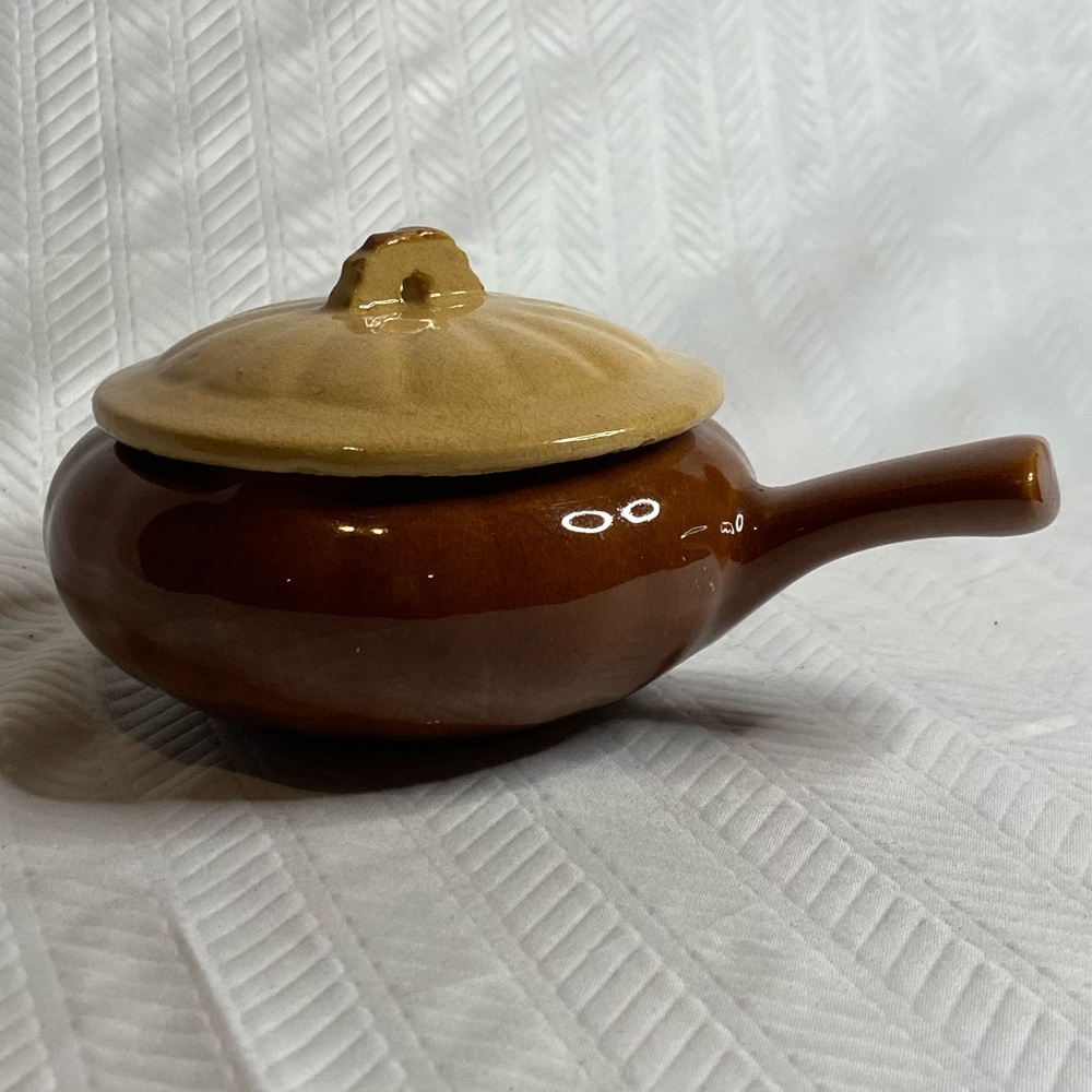 Glazed pottery soup bowl with lid and handle.